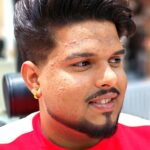 “Barber giving textured crop haircut at men’s salon in Business Bay”